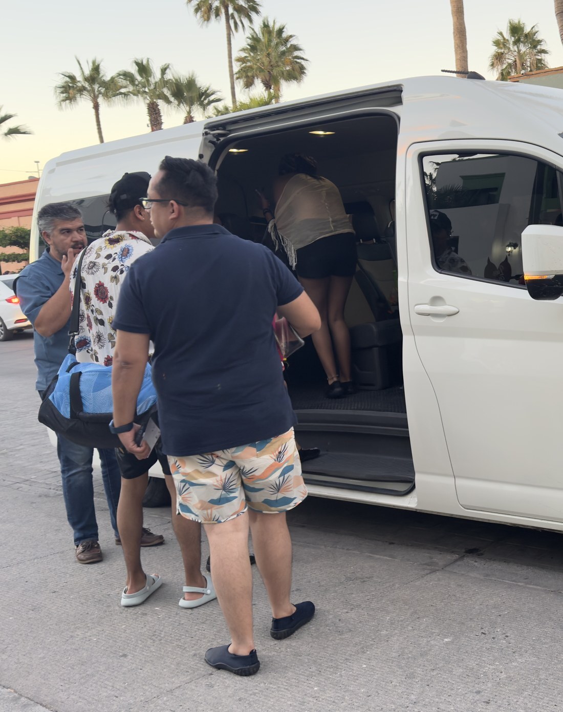 Travelers boarding a private tour van at dusk in La Paz, Baja California Surcard2_final
