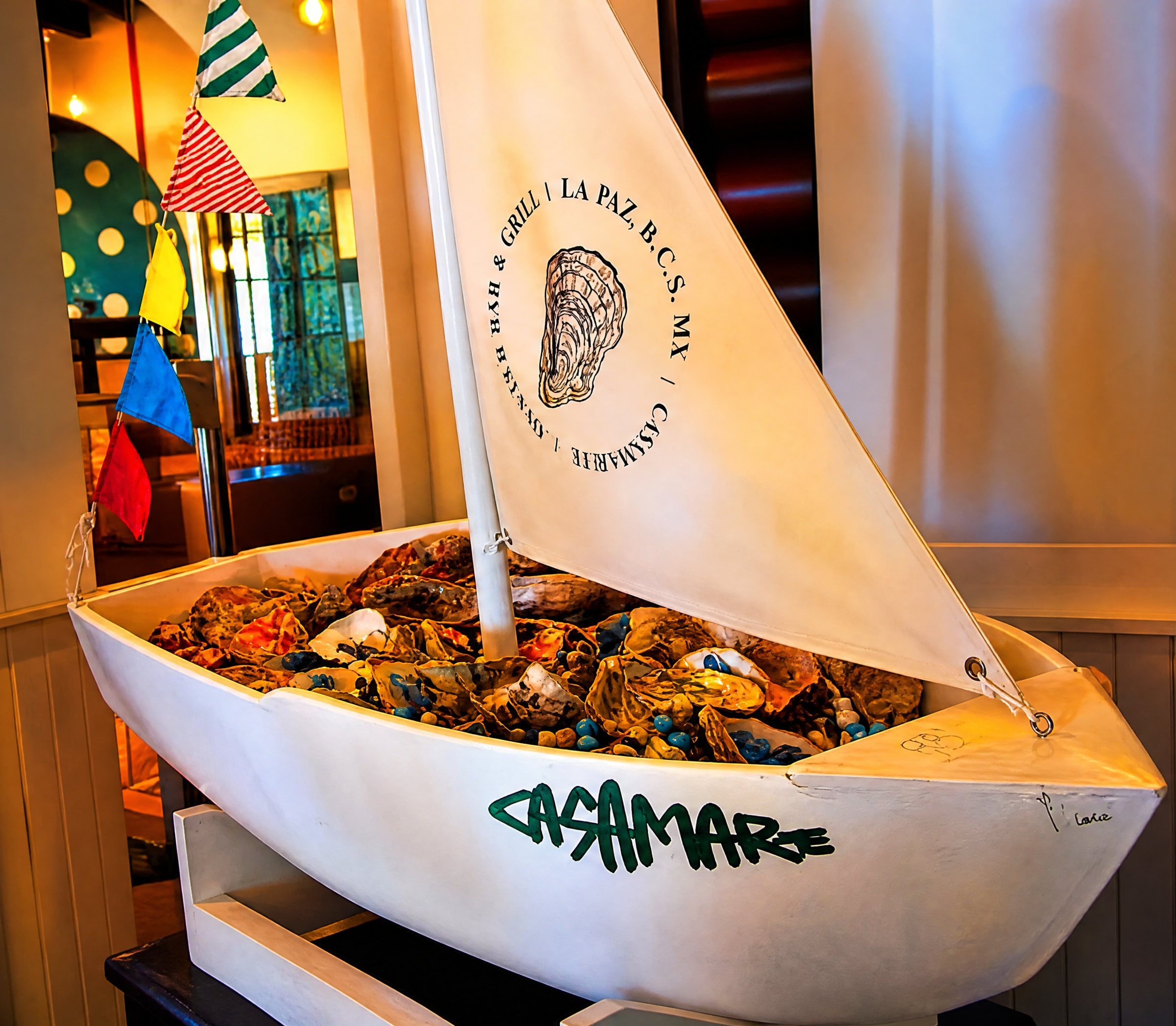 Decorative sailboat full of oysters at the Casamarte entrance, La Paz