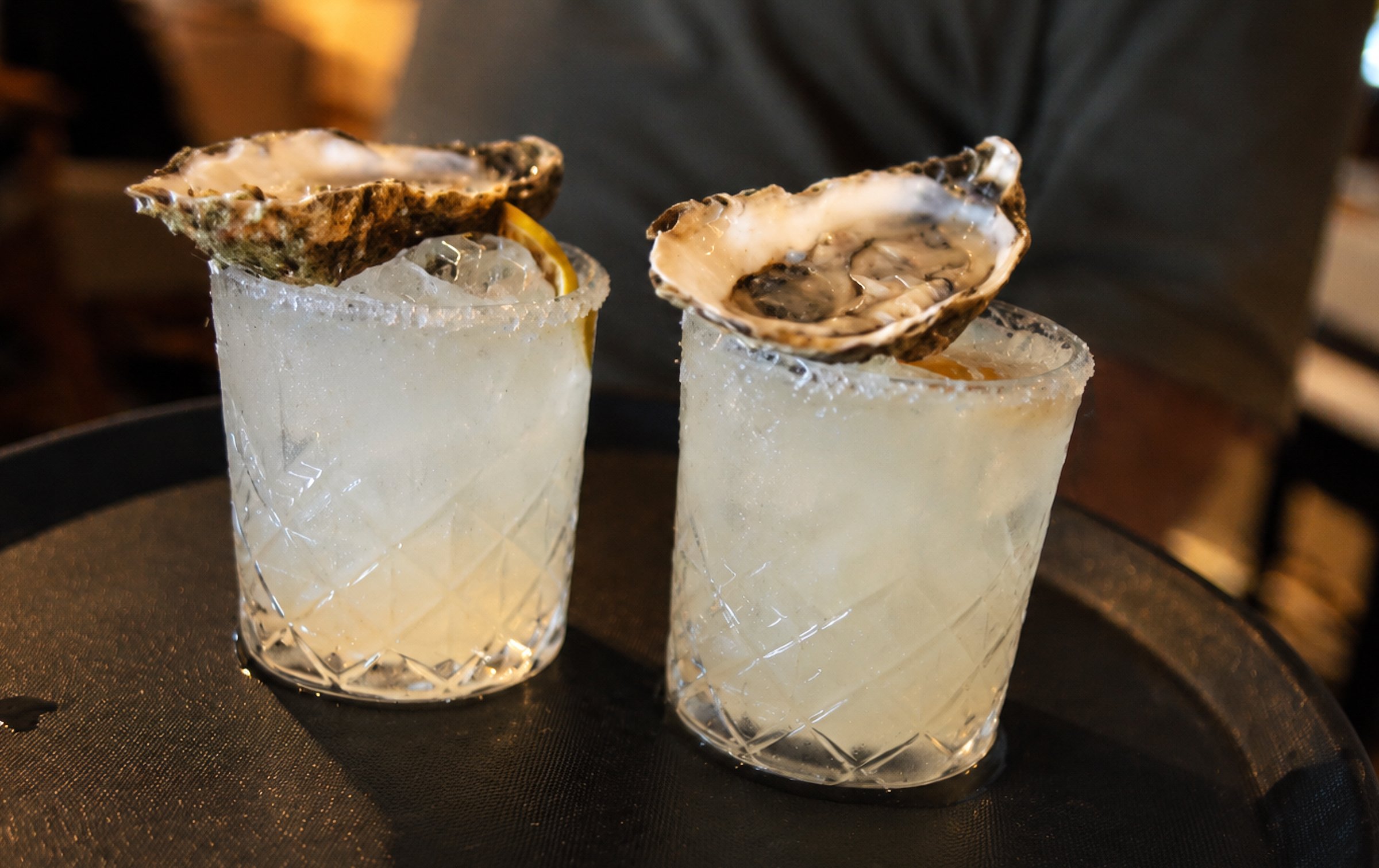 Two cocktails garnished with oyster shells, welcome drink at Casamarte
