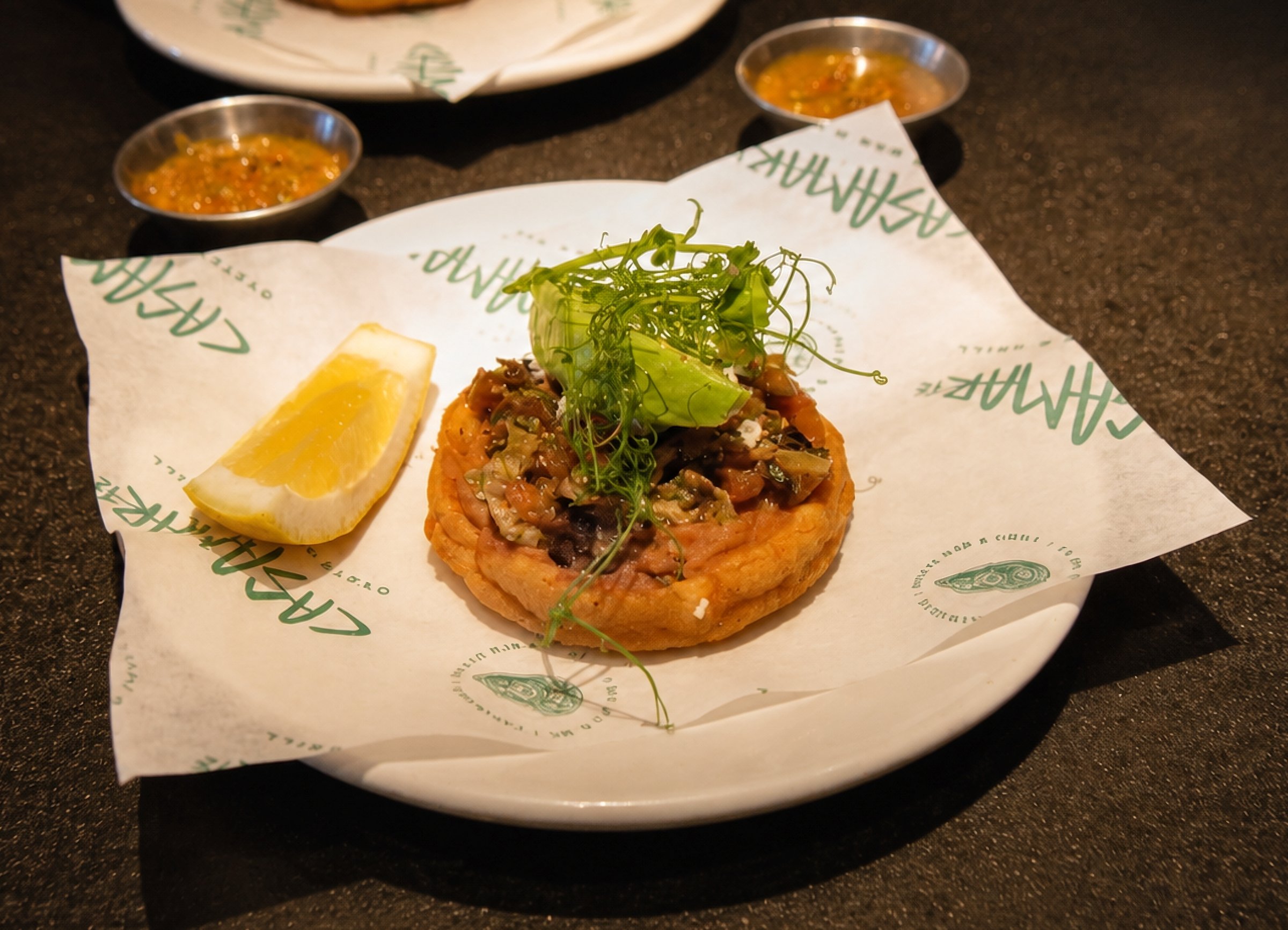 Tostada topped with seafood and pea shoots at Casamarte Oyster Bar & Grill